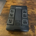 Cyberpower HT600WSU2A 6-OUTLET 500V Wall Mount Surge Protector, Black. Fixed Price $15.00.